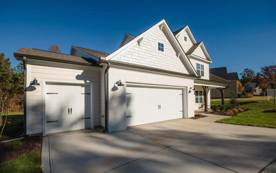 A house with a smaller additional garage, perfect for a golf cart.