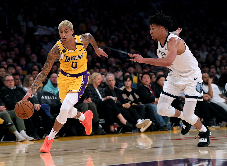 LOS ANGELES, CALIFORNIA - FEBRUARY 21:  Kyle Kuzma #0 of the Los Angeles Lakers dribble past Brandon Clarke #15 of the Memphis Grizzlies at Staples Center on February 21, 2020 in Los Angeles, California.  NOTE TO USER: User expressly acknowledges and agrees that, by downloading and or using this photograph, User is consenting to the terms and conditions of the Getty Images License Agreement. (Photo by Harry How/Getty Images)