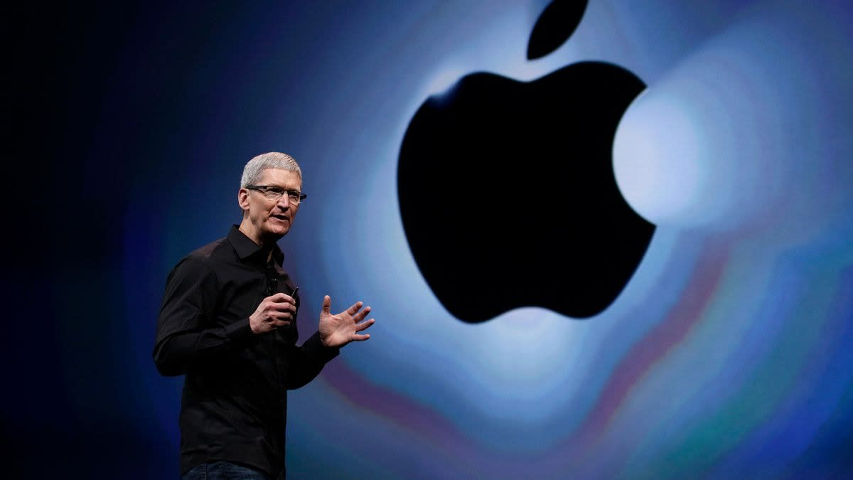  Apple's CEO Tim Cook on stage in front of an Apple logo. 