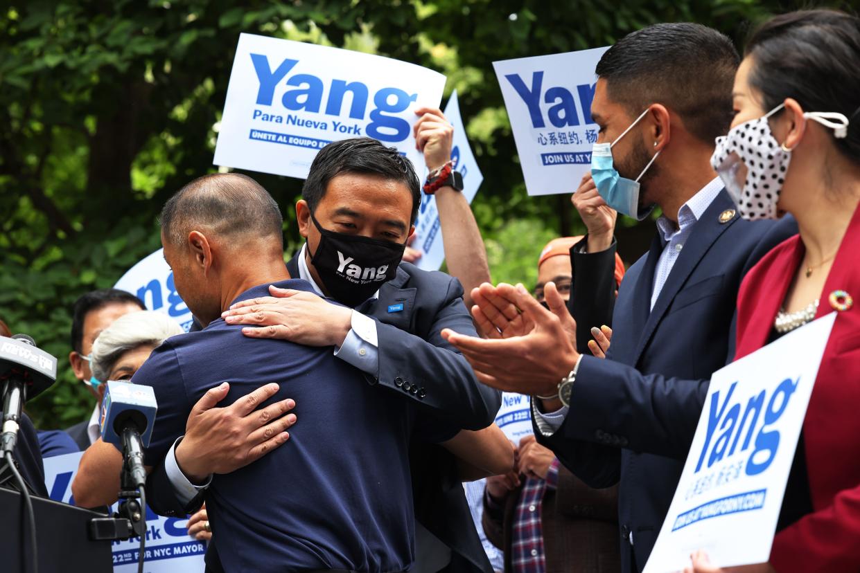 State Senator John C Liu embraces New York City Mayoral candidate Andrew Yang at a rally at City Hall Park in Manhattan on May 24, in New York City. Yang held a rally today where he received the endorsement of State Senator John C. Liu. 