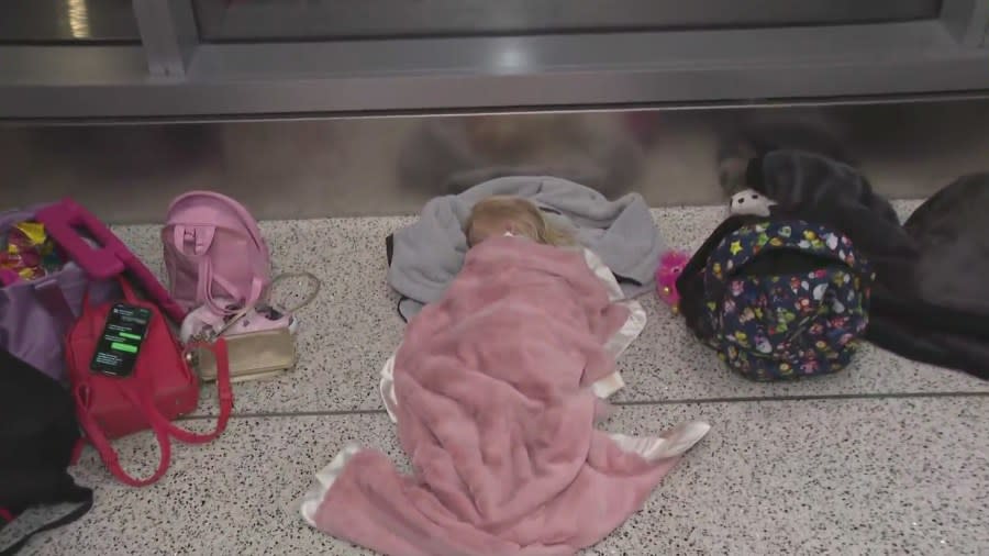 A child sleeps on the floor of the Delta terminal at LAX on July 23, 2024.