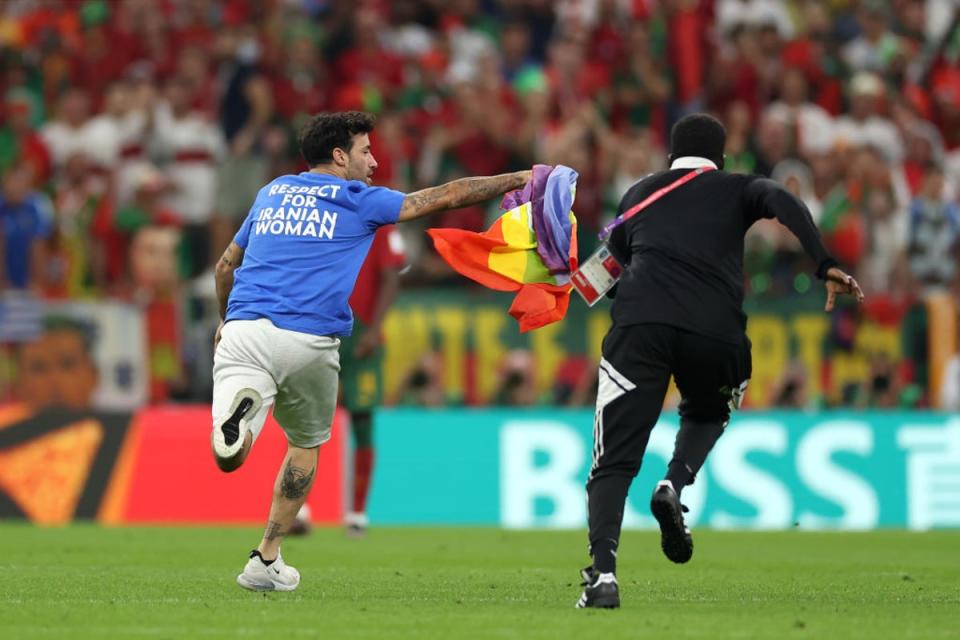 A pitch invader carrying a rainbow flag stopped play on Monday (Getty Images)