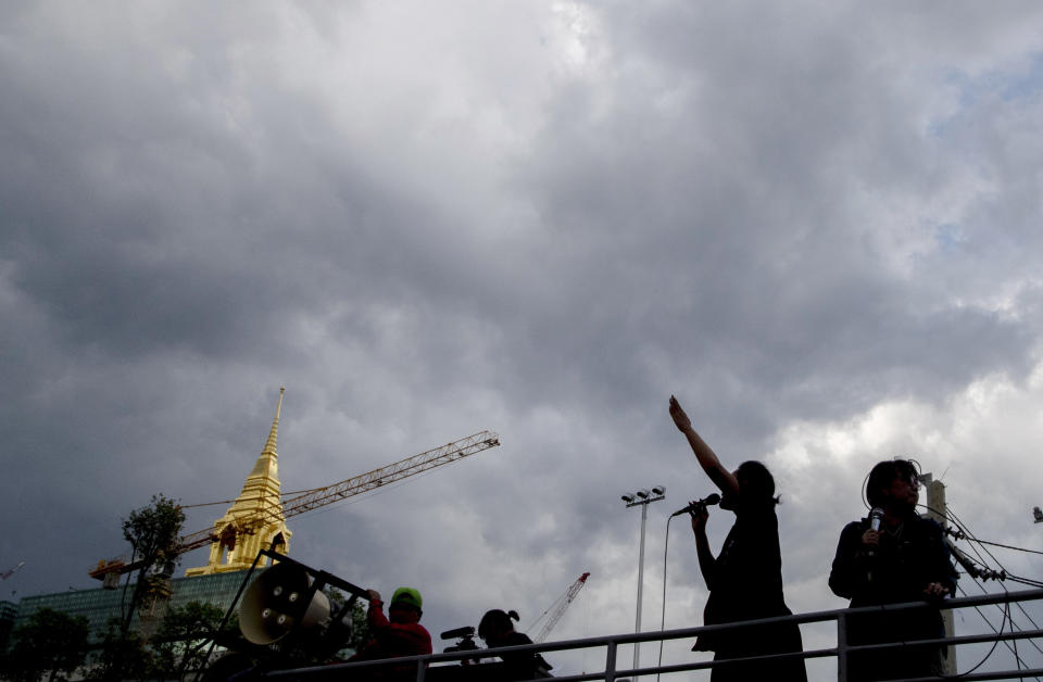 Pro-democracy demonstrators standing in the back of a truck flashing a three-fingered salute, the movement's symbol of resistance, during a protest outside the Parliament in Bangkok, Thailand, Thursday, Sept. 24, 2020. Lawmakers in Thailand are expected to vote Thursday on six proposed amendments to the constitution, as protesters supporting pro-democratic charter reforms gathered outside the parliament building. (AP Photo/Gemunu Amarasinghe)