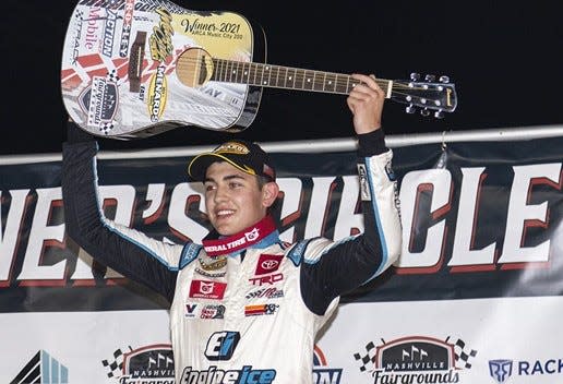 Sammy Smith, 16, shows off the guitar trophy he won after claiming the Music City 200 in the ARCA Menards East Series race Saturday night at Nashville Fairgrounds Speedway.