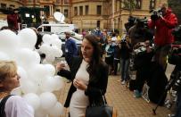 Aimee Pistorius (C), sister of South African Olympic and Paralympic sprinter Oscar Pistorius, is greeted by a supporter as she arrives for her brother's trial at the North Gauteng High Court in Pretoria, April 14, 2014. Pistorius is on trial for murdering his girlfriend Reeva Steenkamp at his suburban Pretoria home on Valentine's Day last year. He says he mistook her for an intruder. REUTERS/Siphiwe Sibeko (SOUTH AFRICA - Tags: CRIME LAW SPORT ATHLETICS)