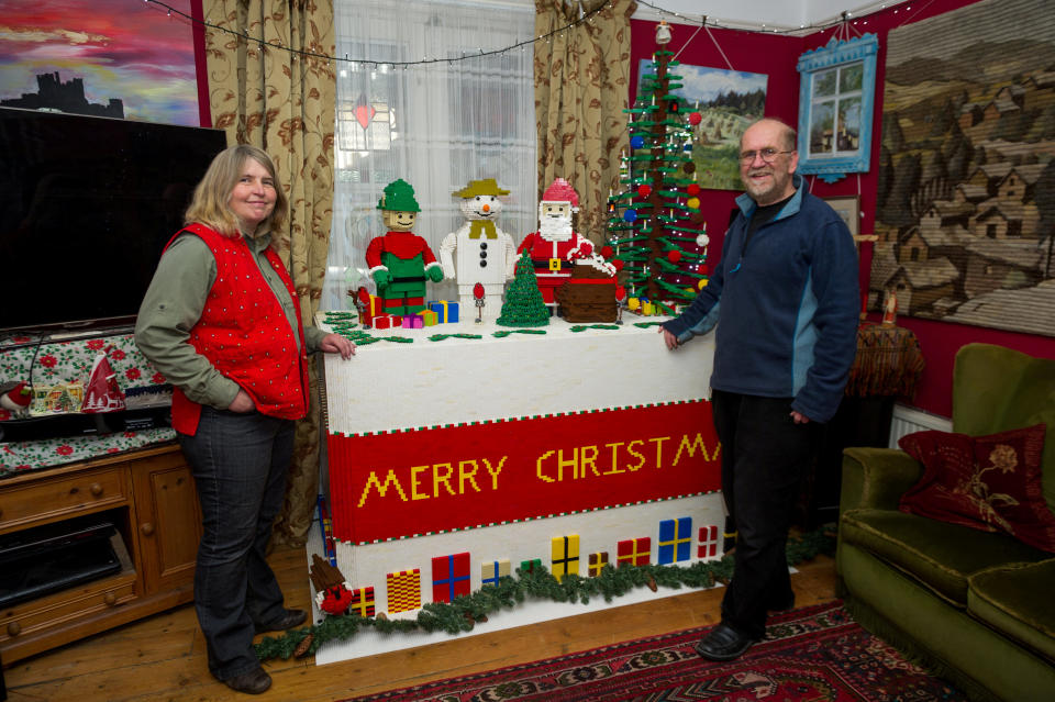 One of the Addis family's previous Christmas Lego creations. -Mike Addis and his wife Catherine Weightman with their Christmas cake 2015. (file photo) See SWNS story SWCAlego. A Lego-mad couple have spent four weeks working 14 hours a day to create this stunning 21-foot-long replica of Old London Bridge in their own sitting room. Every year Mike Addis, 63, and Catherine Weightman, 58, build a massive Lego creation in time for Christmas. And their 27th project has just been completed using 400,000 Lego bricks. They have recreated Old London Bridge of 1400, one of several bridges which spanned the Thames at Southwark, including 78 houses, 500 mini-figures, a castle and chapel.  