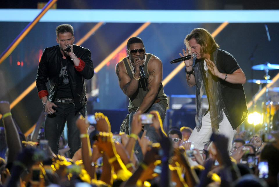Brian Kelley, left, and Tyler Hubbard, right, of musical group Florida Georgia Line, and Nelly perform at the 2013 CMT Music Awards at Bridgestone Arena on Wednesday, June 5, 2013, in Nashville, Tenn. (Photo by Donn Jones/Invision/AP)