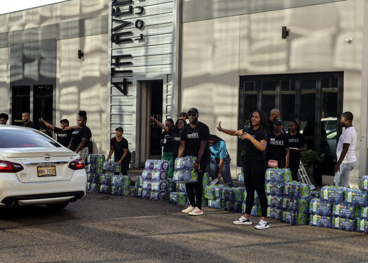 Volunteers distribute water during a water shortage in Jackson, Mississippi