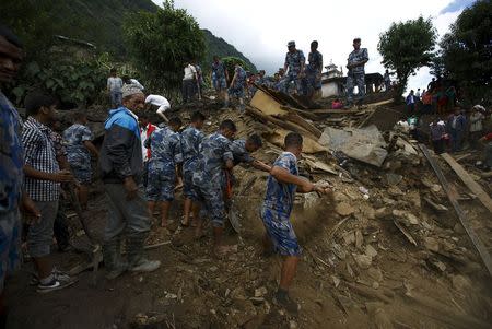 Rescue team members search for the landslide victims at Lumle village in Kaski district July 30, 2015. REUTERS/Navesh Chitrakar