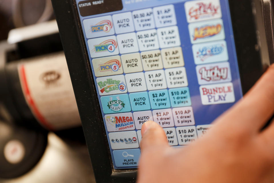 A Mega Millions transaction is processed at the Street Corner Market, Wednesday, Oct. 17, 2018, in Cincinnati. The estimated jackpot for Friday's drawing would be the second-largest lottery prize in U.S. history with a jackpot estimated to exceed $900 million. (AP Photo/John Minchillo)