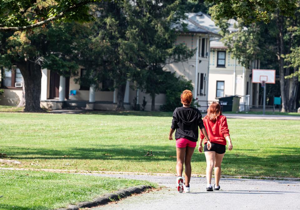 Residents of the Pleasantville Cottage School, a residential treatment center run by JCCA, walk back to their cottage after school Sept. 7, 2023. The residential treatment center has come under criticism from some Mount Pleasant residents who are calling for it be closed due to the number of police incidents involving its young residents.