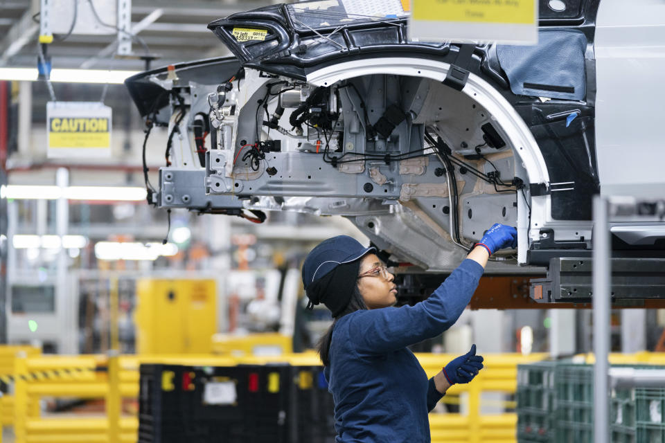 FILE - An employee works in the X3 X4 assembly hall at the BMW Spartanburg plant in Greer, S.C. Wednesday, Oct. 19, 2022. A wave of retirements, a drop in legal immigration, and hundreds of thousands of COVID-19 deaths have left the U.S. with a smaller workforce than when the pandemic began two and half years ago, a change that could bolster wage growth and inflation and force the Federal Reserve to keep interest rates higher for longer. (AP Photo/Sean Rayford, File)