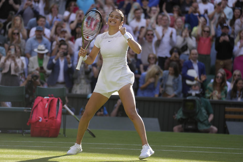 Britain's Emma Raducanu celebrates beating Belgium's Alison van Uytvanck to win a women's first round singles match on day one of the Wimbledon tennis championships in London, Monday, June 27, 2022. (AP Photo/Kirsty Wigglesworth)