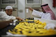 Workers embroider the Kiswa, a silk cloth covering the Holy Kaaba, in the holy city of Mecca, ahead of the annual haj pilgrimage October 8, 2013. REUTERS/Ibraheem Abu Mustafa