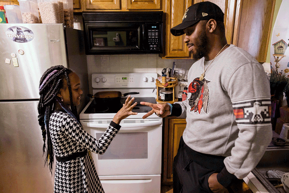 Parker and his daughter in the kitchen before headling out. (Rosem Morton for NBC News)
