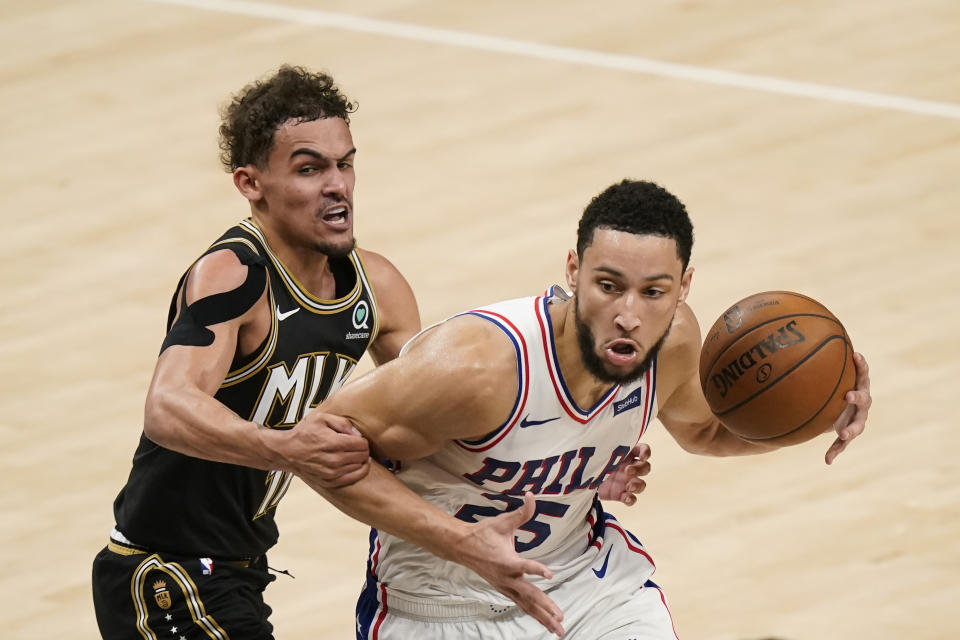 Atlanta Hawks' Trae Young (11) fouls Philadelphia 76ers' Ben Simmons (25) during the first half of Game 4 of a second-round NBA basketball playoff series on Monday, June 14, 2021, in Atlanta. (AP Photo/Brynn Anderson)