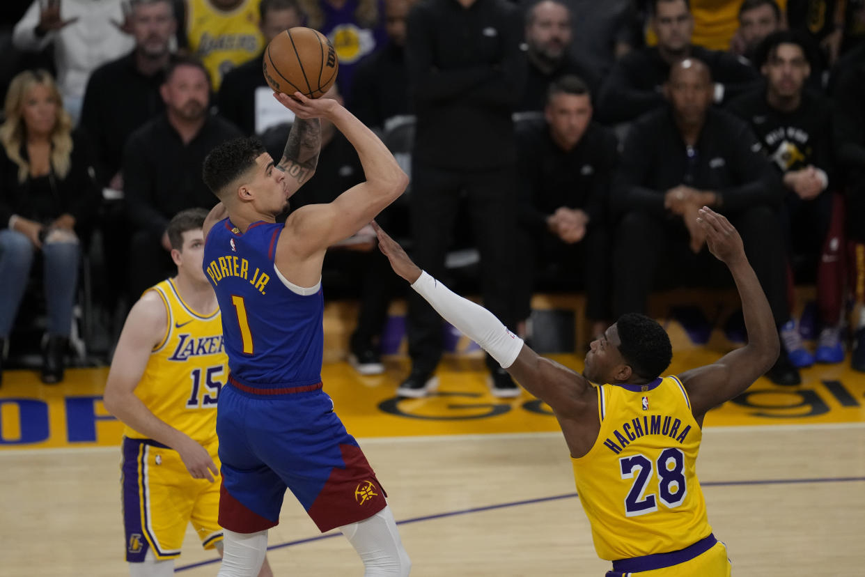 Denver Nuggets forward Michael Porter Jr. (1) shoots against Los Angeles Lakers forward Rui Hachimura (28) during the first half of Game 3 of an NBA basketball first-round playoff series in Los Angeles, Thursday, April 25, 2024. (AP Photo/Ashley Landis)