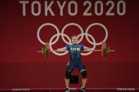 Polina Guryeva of Turkmekistan competes in the women's 59kg weightlifting event, at the 2020 Summer Olympics, Tuesday, July 27, 2021, in Tokyo, Japan. (AP Photo/Luca Bruno)