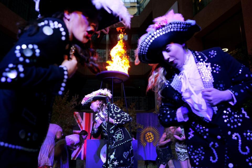 Song and dance troupe the West End Kids perform in front of a Platinum Jubilee beacon after it was lit at Coutts bank in central London (PA)