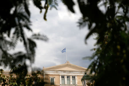 A Greek flag flutters atop the parliament building in Athens, Greece, June 21, 2018. REUTERS/Costas Baltas