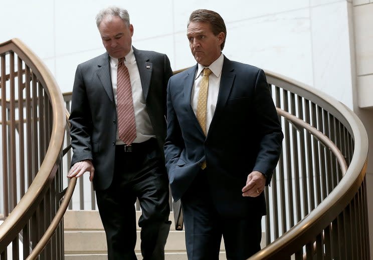 Sens. Jeff Flake, R-Ariz., right, and Tim Kaine, Va., walk to a closed briefing. (Photo: Win McNamee/Getty Images)