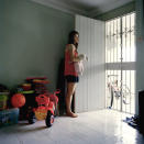 Shine Koh (shinekoh.com) stands by the door of her modest home. Koh is no stranger to TV having done print and TV advertisements, as well as dabbling in acting.