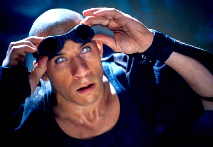 Vin Diesel as Riddick, wearing goggles on his head looking up