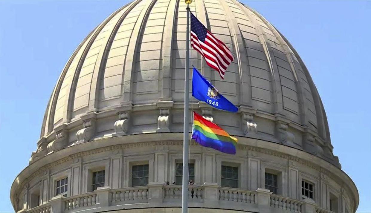 A rainbow flag observing Pride Month is displayed over the east wing of the Wisconsin State Capitol in Madison, Wis.