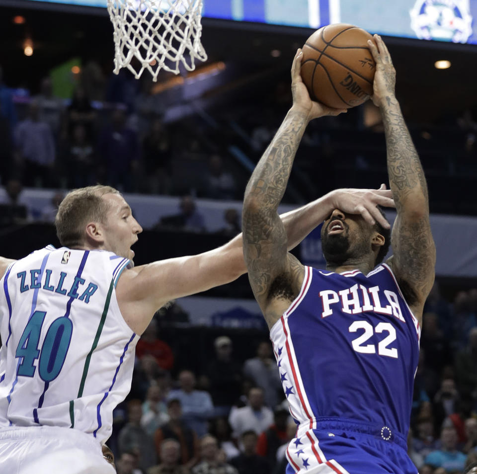 Philadelphia 76ers' Wilson Chandler (22) is fouled by Charlotte Hornets' Cody Zeller (40) during the second half of an NBA basketball game in Charlotte, N.C., Saturday, Nov. 17, 2018. (AP Photo/Chuck Burton)
