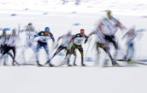 <p>In this photo taken with slow shutter speed Germany’s Fabian Riessle, center, competes during 10-kilometer cross-country race of the Normal Hill Nordic Combined competition at the 2017 Nordic Skiing World Championships in Lahti, Finland, Friday, Feb. 24, 2017. (Photo: Matthias Schrader/AP) </p>