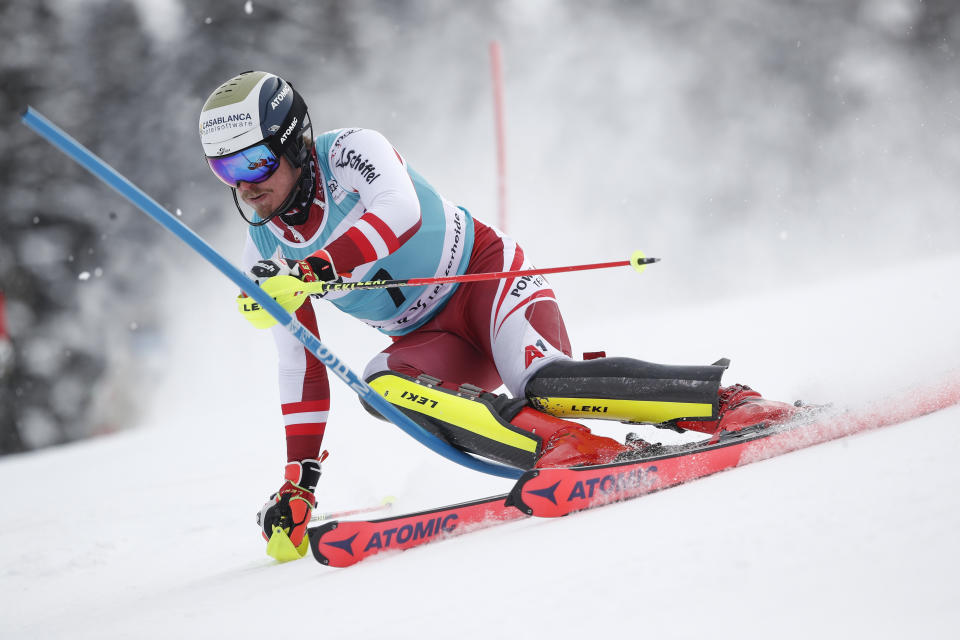 Austria's Manuel Feller speeds down the course during an alpine ski, men's World Cup slalom, in Lenzerheide, Switzerland, Sunday, March 21, 2021. (AP Photo/Gabriele Facciotti)