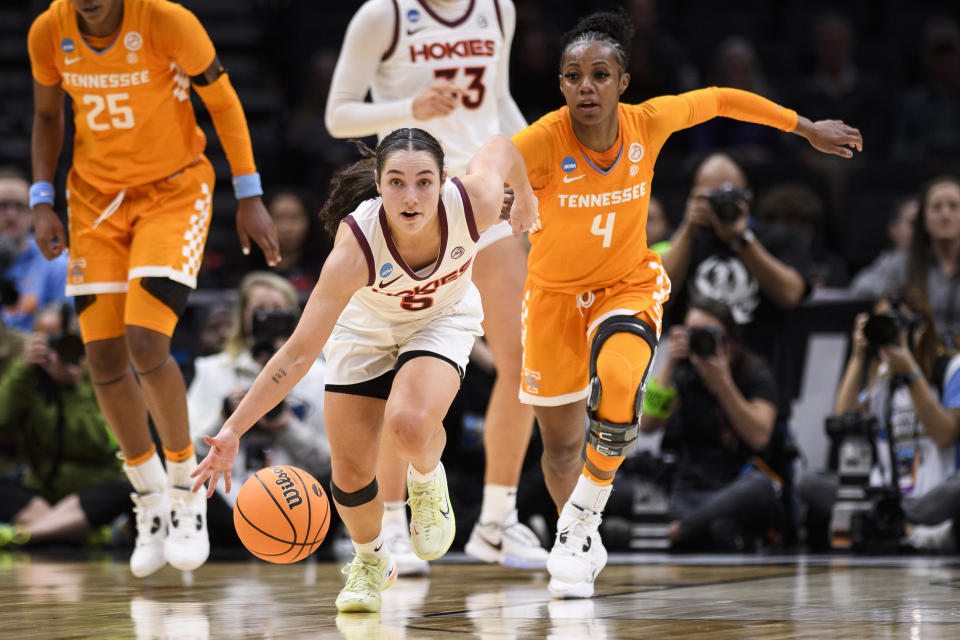 Virginia Tech guard Georgia Amoore (5) dribbles down court after stealing the ball off of Tennessee guard Jordan Walker (4) in the third quarter of a Sweet 16 college basketball game of the NCAA Tournament in Seattle, Saturday, March 25, 2023. (AP Photo/Caean Couto)