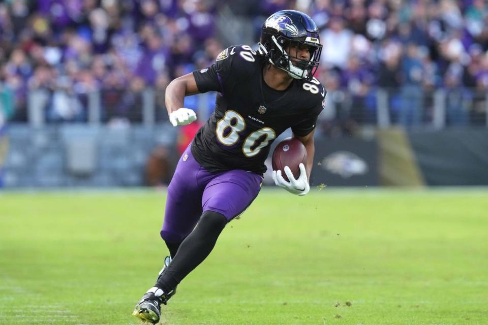 Dec 31, 2023; Baltimore, Maryland, USA; Baltimore Ravens tight end Isaiah Likely (80) runs following his catch for a second quarter touchdown against the Miami Dolphins at M&T Bank Stadium. Mandatory Credit: Mitch Stringer-USA TODAY Sports