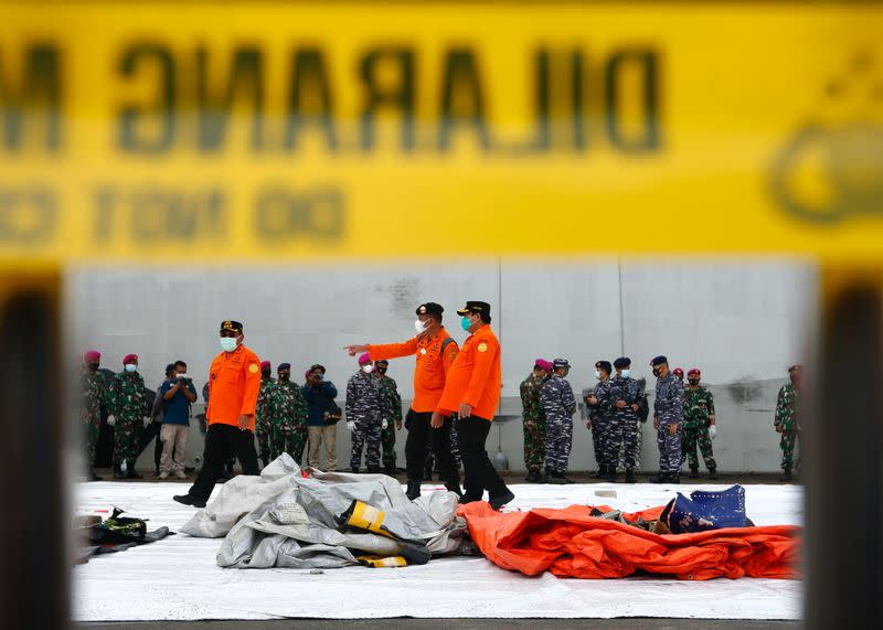 Indonesian rescue members look at what is believed to be the remains of the Sriwijaya Air plane flight SJ182, which crashed into the sea, at Jakarta International Container Terminal port in Jakarta