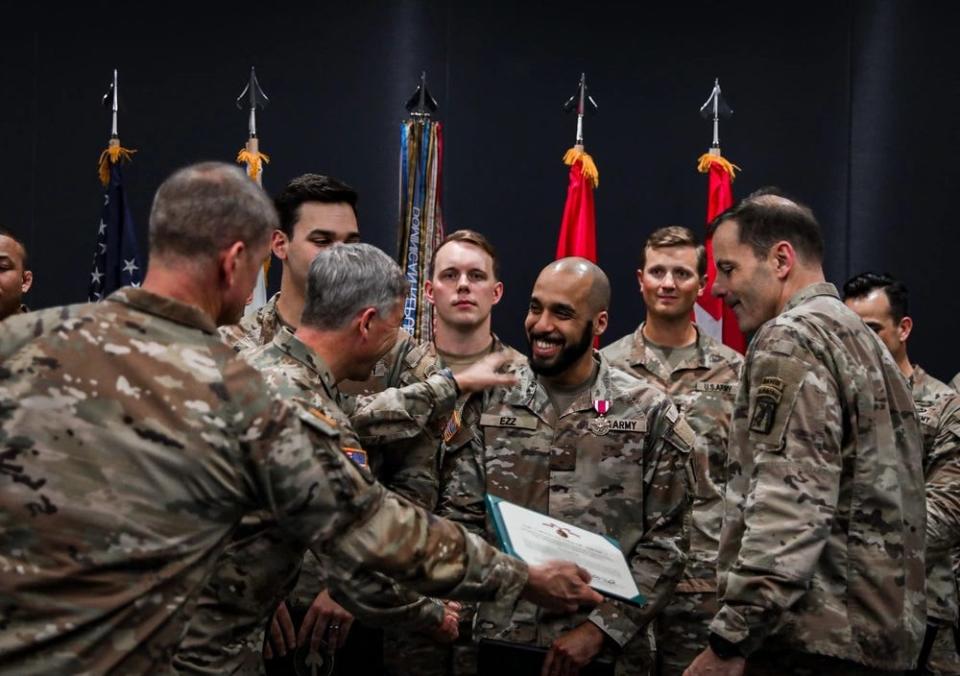 1st Lt. Aliperti and Pvt. Ezz, assigned to the Marne Innovation Lab, 3rd Infantry Division, based at Fort Stewart, Georgia, are named the winners of "Dragon's Lair 8" and awarded the Meritorious Service Medal by Gen. Bryan P. Fenton, commander of the U.S. Special Operations Command, Lt. Gen. Christopher Donahue, commanding general of the 18th Airborne Corps, and Command Sgt. Maj. Thomas Holland, senior enlisted advisor for the 18th Airborne Corps on March 29, 2023, at the University of South Florida Inventors Research Park in Tampa, Florida.