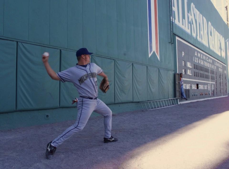 Jeromy Burnitz of the Milwaukee Brewers practices on the track in front of the Green Monster during workouts before the All-Star game Tuesday, July 13, 1999 at Boston's Fenway Park.