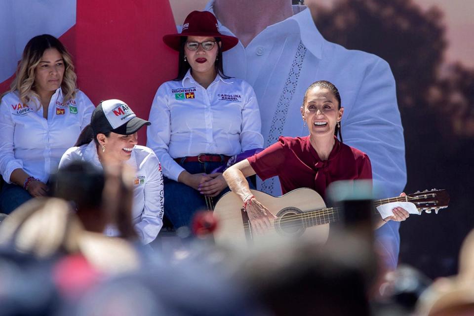 Mexican leftist presidential candidate Claudia Sheinbaum plays the guitar during a campaign rally at the Morelos stadium in Morelia, Michoacan State, Mexico, on March 9, 2024.