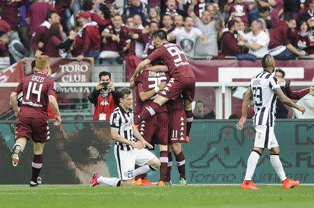 Torino's Fabio Quagliarella (not seen) celebrates with his team mates after scoring against Juventus during their Italian Serie A soccer match at Olympic Stadium in Turin April 26, 2015. REUTERS/Giorgio Perottino