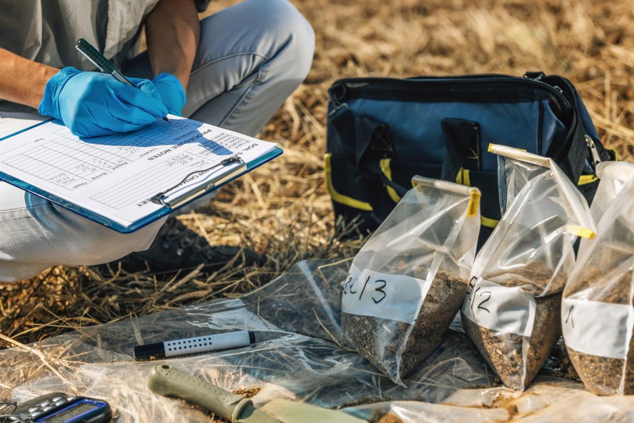 Soil Test. Female agronomist taking notes in the field. Environmental protection, organic soil certification, research