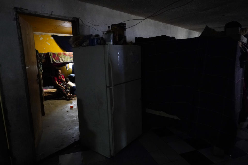 A woman from Honduras sits with her son at a shelter for migrants Friday, May 20, 2022, in Tijuana, Mexico. (AP Photo/Gregory Bull)