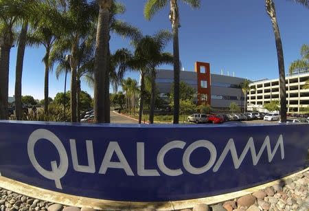 A Qualcomm sign is pictured in front of one of its many buildings in San Diego, California November 5, 2014. REUTERS/Mike Blake/Files