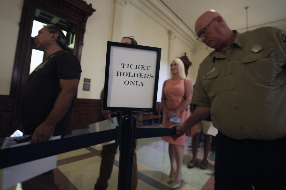 Ticketed members of the public line up outside the Texas State Senate Gallery waiting to enter to watch the impeachment trial of Texas Attorney General Ken Paxton in Austin, Tuesday, Sept. 5, 2023. (AP Photo/LM Otero)