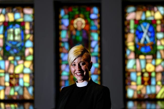 The Rev. Katie Churchwell, dean of St. Paul's Episcopal Cathedral, stands in front of stained glass windows at the downtown Oklahoma City church, 127 NW 7.