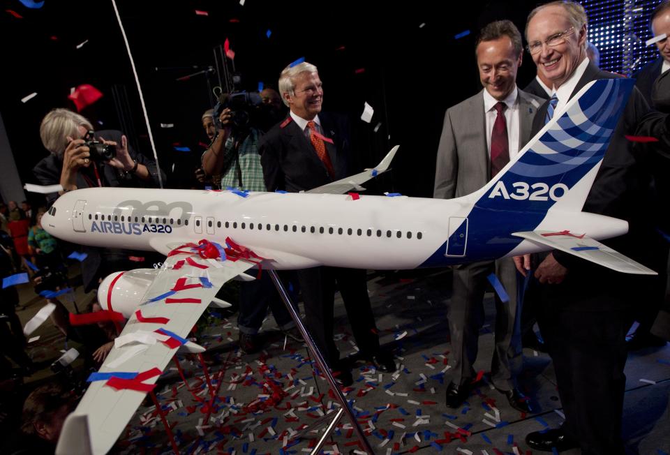 Alabama Gov. Robert Bentley, right, and Airbus President & CEO Fabrice Bregier celebrate the announcement that Airbus will establish its first assembly plant in the United States in Mobile, Ala., Monday, July 2, 2012. The French-based company said the Alabama plant is expected to cost $600 million to build and will employ 1,000 people when it reaches full production, likely to be four planes a month by 2017. (AP Photo/Dave Martin)