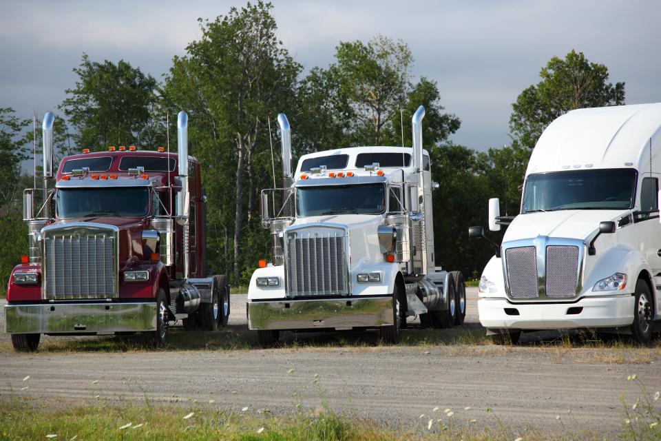 Semi trucks parked in a parking lot