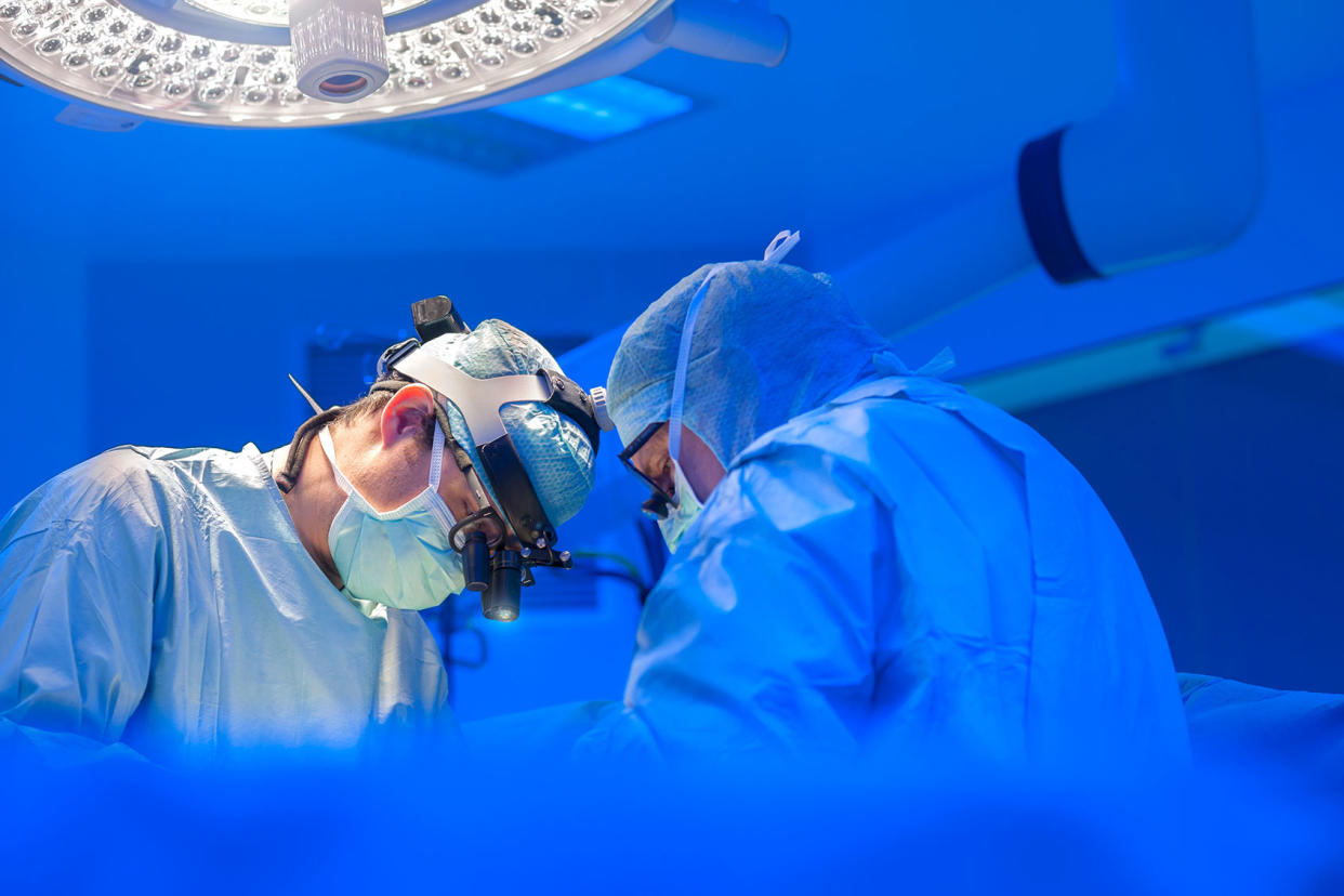 Surgeons performing open heart surgery Getty Images/Thierry Dosogne