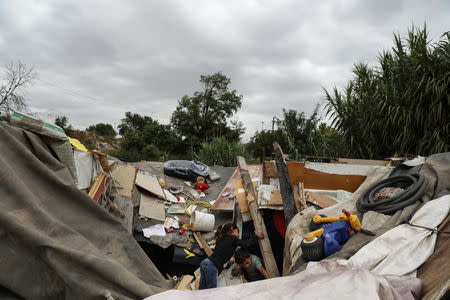 Children look for toys to salvage from the debris of the Stan family's hut after it was demolished in El Gallinero shanty town on the outskirts of Madrid, Spain, September 26, 2018. REUTERS/Susana Vera