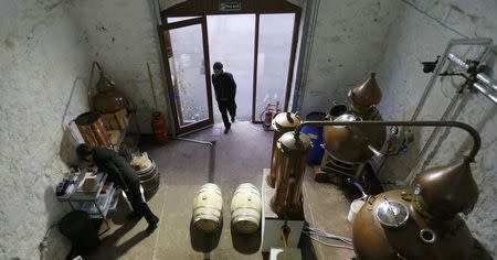 A visitor looks at the whisky and gin distllery at the Strathearn Distillery, Methven, Scotland, Britain December 13, 2016. REUTERS/Russell Cheyne