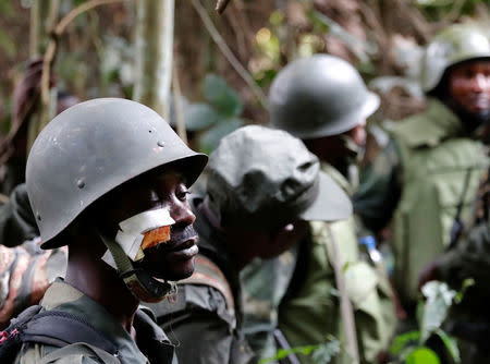 A wounded Congolese soldier from the Armed Forces of the Democratic Republic of Congo (FARDC) rests in the forest after the army took control of a ADF rebel camp, near town of Kimbau, North Kivu Province, Democratic Republic of Congo, February 19, 2018. REUTERS/Goran Tomasevic/Files