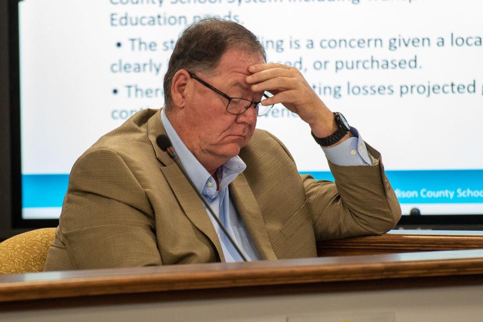 School Board member Harvey Walden rubs his forehead as American Classical Education's application is being reviewed during the Jackson-Madison County School Board meeting on Thursday, Apr. 27, 2023. 